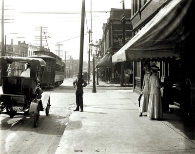 Women and Boy in Front of Storefront on Olive Street Looking Toward Sarah Street by Unbekannt Unbekannt